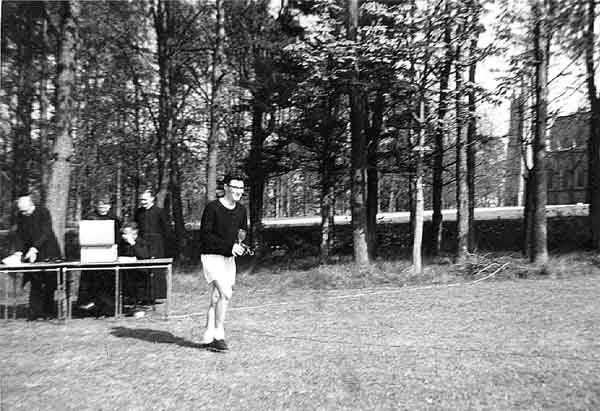 Billy McCarthy lifting sports trophy, 1960