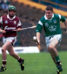 note the careful balance of the sliothar on the caman as he runs without any wimpy face helmet.