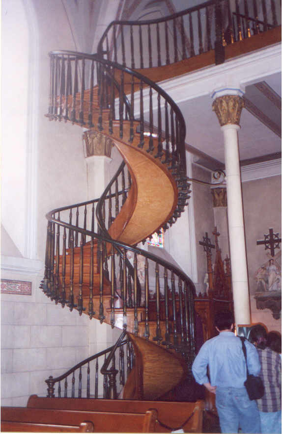 Me (in blue shirt with back to camera) staring at the Miraculous Staircase.  Loretto Chapel.
