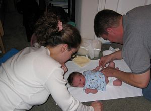 Pic, Mom and Dad learning to diaper Braden.