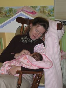 Pic, Eirelyn being rocked in rocking chair