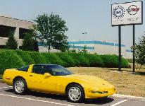 In front of the 'Home of The Corvette' Sign