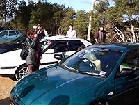Members mingling and talking cars