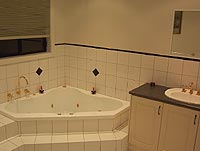 Bathroom Number 1 [of 3], incorporates a nice corner spa.... I am yet to try this thing out