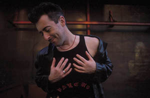 alan in front of a wall