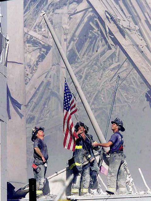Firefighters raising the Flag amid the destruction of the World Trade Center