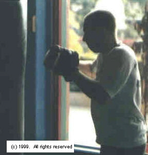 Proper equipment, such as handwraps and quality bag gloves, are essential to a safe and efficient workout.  Image copyright 1999.  All rights reserved.
