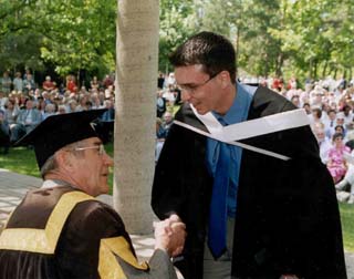 hen-Chancellor of Carleton University Arthur Kroeger congratules Karl during graduation ceremonies.