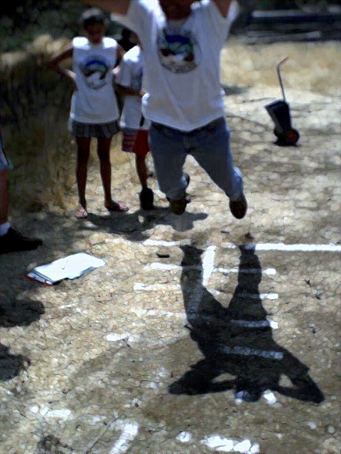Cubmaster is jumping his head off at the standing long jump with the Bears