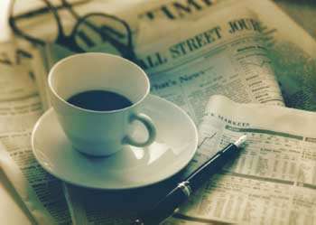 coffee cup standing on newspaper