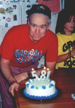 My 59th birthday cake Oct. 10, 1999. Granddaughter Meagan in the background. My wife's humor with the candles. Actually she didn't have a 9.