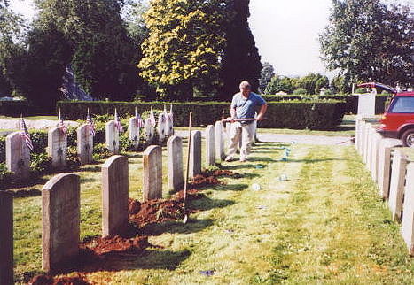 Brother Kennedy digging holes for G.A.R. grave markers at the Civil War Soldiers and Sailors Burial Plot.