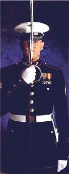 Marine In Dress Blues brandishing the NCO Sword