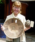 Valerie Gardner of Gardners African Baskets shows off a winnowing basket  and a coiled herb basket from Zimbabwe
