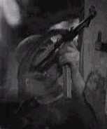 soldier taking aim with MP 40 in urban warfare