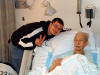 Dad with Dan at Skagit Valley Hospital in Mount Vernon, February 21, 2004.  Dad giving the victory sign, as he often does.