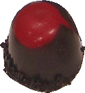 Whole cherry in kirsche in a dark choc bomb with choc sprinkles and red choc top