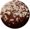White choc and macadamia coated in mild chocolate and white sprinkles