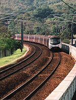 Refurbished e.m.u. set speeds through a curve near Fanling, New Territories, April 18 2007