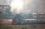 SY 0633 storms the bank with a small train of loaded coal hoppers