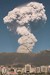 Hidden by the foreground mountains
the volcano roars