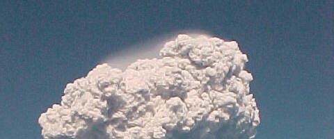 hidden by the foreground
mountains roars the volcano