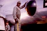 421st hose reel operator in Siagon, Vietnam wearing 38 pistol. B-Flight crew member in background.