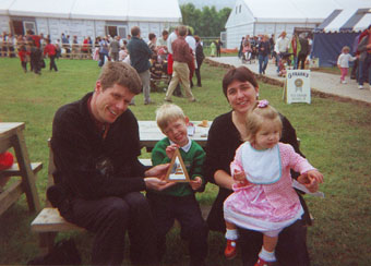 family with trophy for caan actol song competition, sitting at picnic table in Lampeter eyestezthvod in Wales