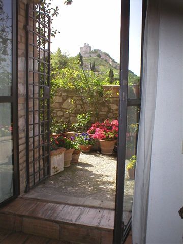 Entrance from the terrace and view of the Rocca Maggiore