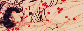 Ami fast asleep in a bed of sheets and rose petals.