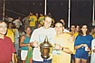 Team captain with cup and supporters