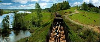 Train along river dance scene