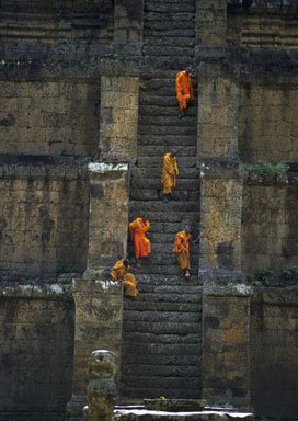 When a wise man has carefully rid himself of carelessness and climbed the High Castle of Wisdom, sorrowless he observes sorrowing people, like a clear-sighted man on a mountain top looking down on the people with limited vision on the ground below