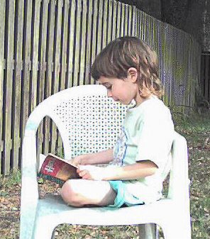 Vincent reading a Harry Potter book outside