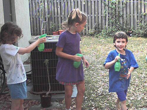 Kathryn, Andrea, and Vincent with spray bottles