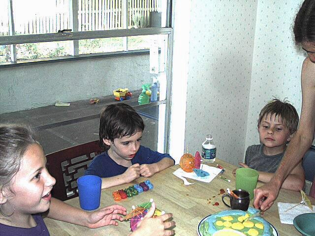 Cake being cut with Vincent, Andrea, and Jackson looking on