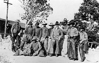 11 WRANGLERS POSE NEAR BRIGHT ANGEL CAMP OFFICE. &quotNORTHERN ARIZONA ROUNDUP CREW." NOV 1919. RYAN.