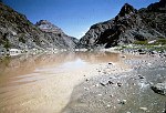 LOOKING UP THE COLORADO AT THE MOUTH OF DIAMOND CREEK, MILE 225. CLEAR WATER COMING IN AT RIGHT IS DIAMOND CREEK. 28 AUG 1963. NPS, BELKNAP 148