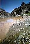 LOOKING UP THE COLORADO AT THE MOUTH OF DIAMOND CREEK, MILE 225. CLEAR WATER COMING IN AT RIGHT IS DIAMOND CREEK. 28 AUG 1963. NPS, BELKNAP 151