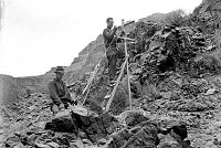 TRANS-CANYON TELEPHONE LINE CONSTRUCTION -  2 CCC ENROLLES RIGGING A PHONE POLE IN THE INNER CANYON BELOW THE TONTO PLATFORM. CIRCA 1935. NPS PHOTO BY LAWS.<br><br>