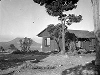 FRED HARVEY REST HOUSE AT DESERT VIEW, WAS A TEMPORARY STRUCTURE BUILT SUMMER OF 1931 - PRIOR TO CONSTRUCTION OF THE WATCHTOWER. CEDAR MOUNTAIN BEYOND. SEPT 1931 NPS PHOTO BY COLLINS
