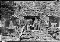 NPS & PARK OFFICIALS POSE BY THE DOOR TO THE DESERT VIEW WATCHTOWER KIVA. LEFT TO RIGHT: ASST SUPT' PRESTON PATRAW, SUP'T M.R. TILLOTSON, __________, DIR OF NPS ARNO B. CAMERER, ______________, FRED HARVEY GENRAL MANAGER VICTOR PETROSSO, WATCHTOWER MA