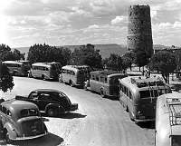 FRED HARVEY TOUR BUSSES PARKED IN FRONT OF THE DESERT VIEW WATCHTOWER. CIRCA 1938 NPS.