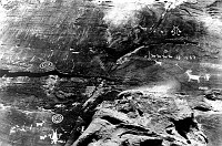 PETROGLYPHS OF HUNTERS, ANIMALS, SPIRALS (FROM PETRIFIED FOREST?) REPRODUCED IN DESERT VIEW WATCHTOWER. GRCA 22624 15 JUNE 1932. PHOTO BY COLTER.