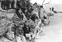 2 HOPI WOMEN & 4 CHILDREN SIT OUTSIDE ON ROCKS AT DEDICATION OF DESERT VIEW WATCHTOWER. 13 MAY 1933. FRED HARVEY CO. 