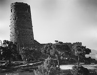 FRONT ELEVATION - DESERT VIEW WATCHTOWER & KIVA AT SUNSET. LIGHT FROM EAST. CIRCA 1933. FRED HARVEY CO. GRCA 15927