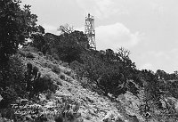 MAN ON TOWER. USED DURING WATCHTOWER CONSTRUCTION FROM BELOW DESERT VIEW POINT. CIRCA 1932. FRED HARVEY CO. 