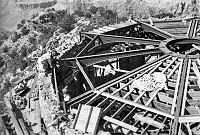 WATCHTOWER CONSTRUCTION SITE. VIEW DOWN ONTO TOP OF PARTIALLY COMPLETED KIVA ROOM. WORKMAN. CIRCA 1931. COLTER