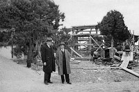 WATCHTOWER CONSTRUCTION SITE. OFFICIALS STANDING IN FRONT OF KIVA FRAMEWORK. 