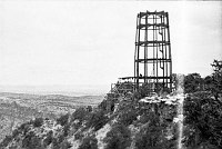 WATCHTOWER CONSTRUCTION SITE. STEEL GIRDERS OF WATCHTOWER FRAMEWORK ON EDGE OF CANYON. CIRCA 1931. COLTER. 